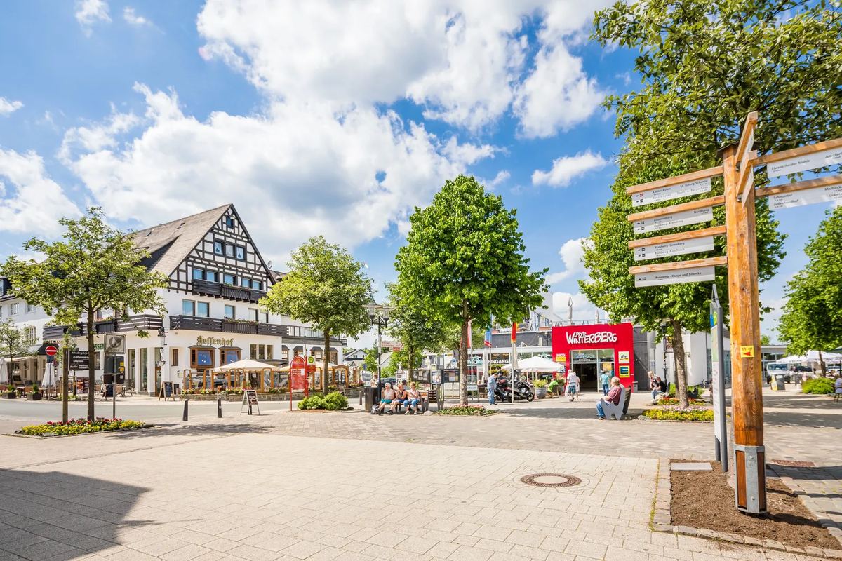 Platz im Ort Winterberg mit Wegweiser